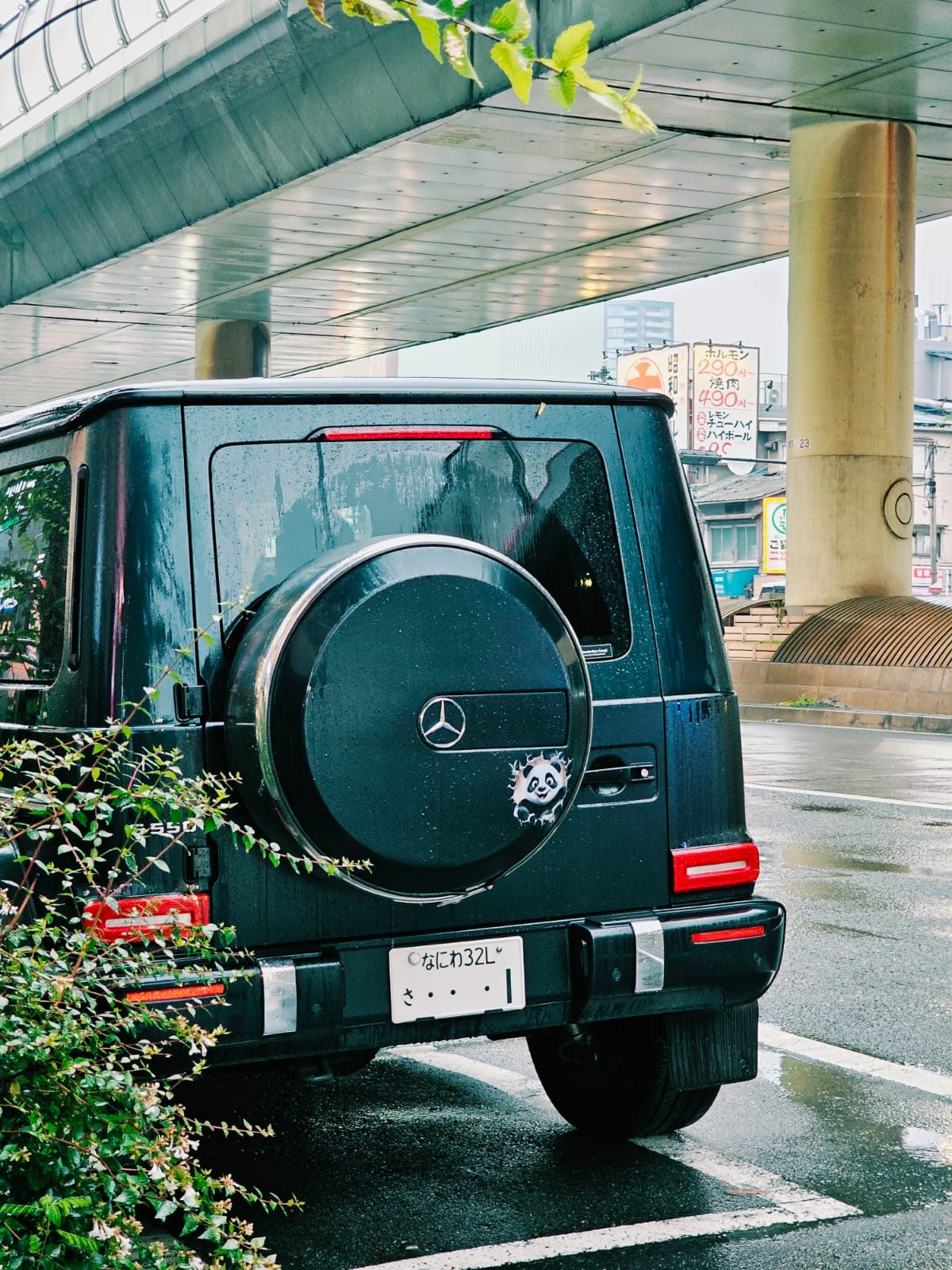 Black Mercedes-Benz G550 rear with a panda sticker on the spare wheel cover