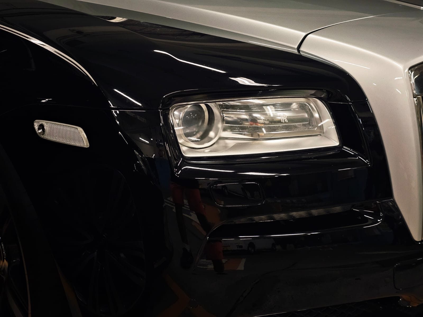 Close-up of a black Rolls-Royce headlamp