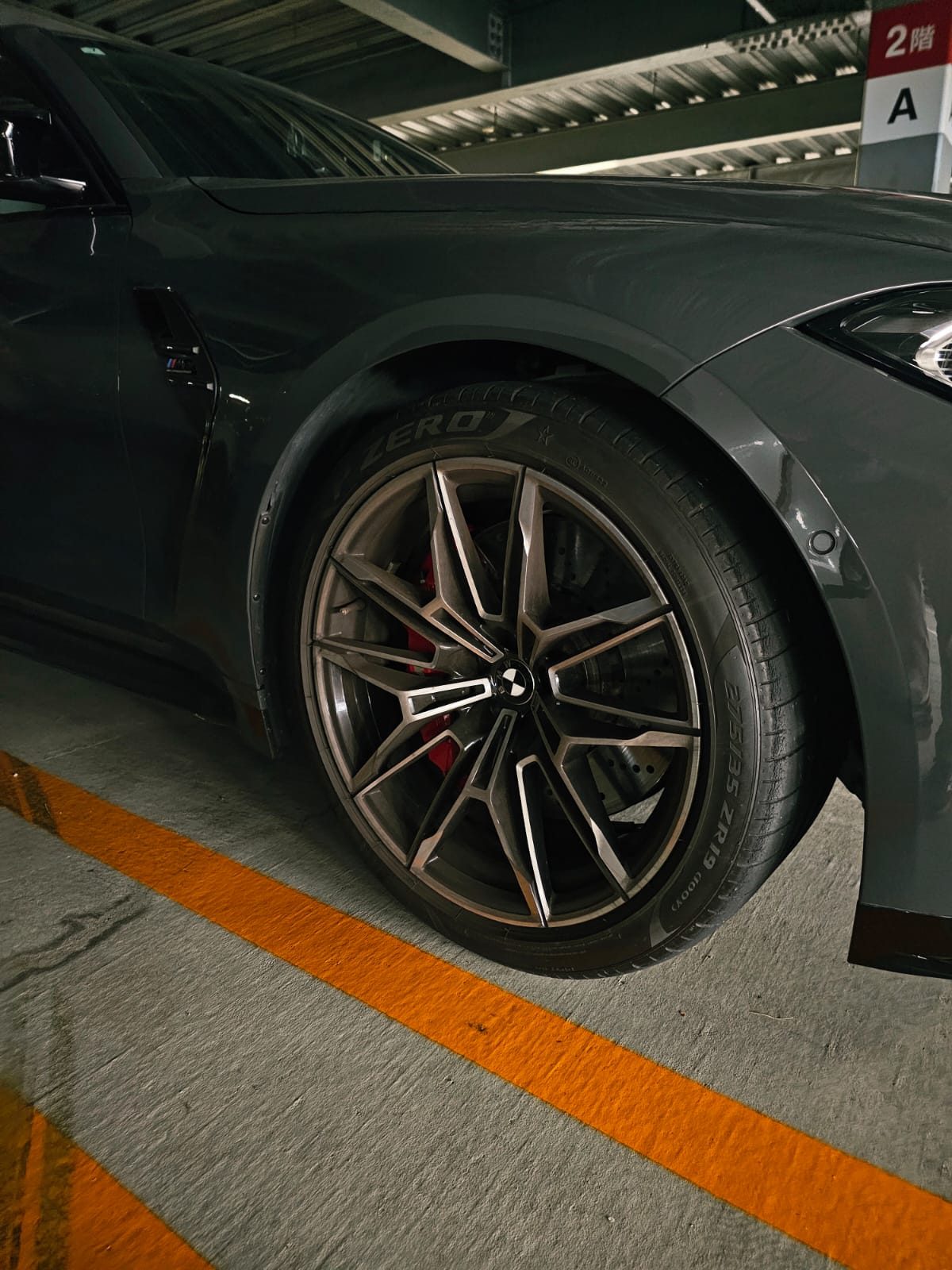 Close-up of the BMW's wheel with red brake calipers