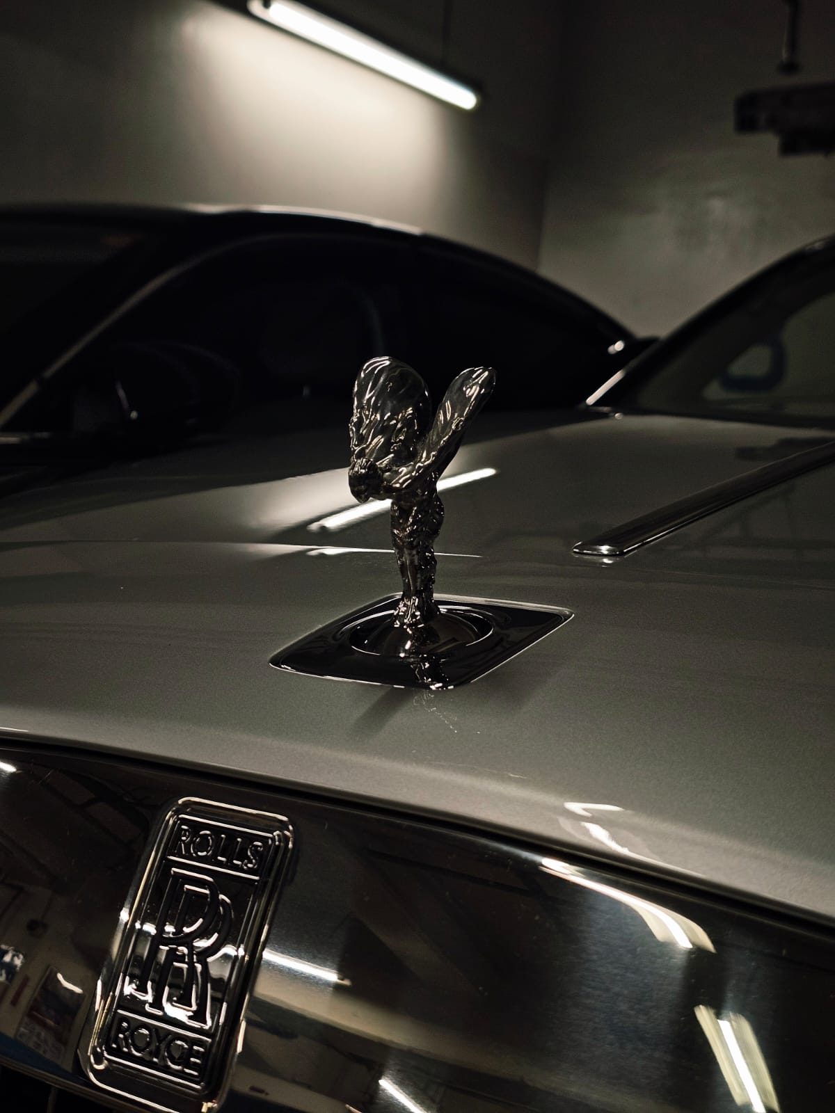 Close-up of the Rolls-Royce Spirit of Ecstasy hood ornament and RR badge